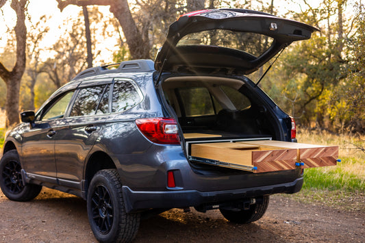 subaru outback camper with drawers and sleeping platform in the forest